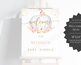 May include: A white pumpkin with pink and white flowers and gold glitter, a welcome sign for a baby shower. The sign says "Welcome to Melissa's Baby Shower".