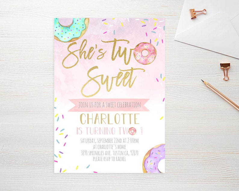May include: Pink and white birthday invitation with gold lettering that says "She's Two Sweet". The invitation features a donut graphic and sprinkles. The text also includes the name Charlotte, the date, time, and location of the party, and an RSVP request.