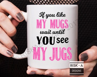 May include: White ceramic mug with a pink and black design. The mug reads "If you like my mugs wait until you see my jugs".