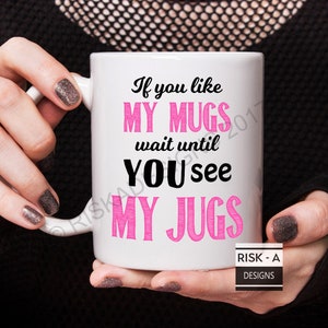 May include: White ceramic mug with a pink and black design. The mug reads "If you like my mugs wait until you see my jugs".