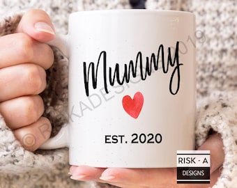 May include: White ceramic mug with black text that reads "Mummy Est. 2020" and a red watercolor heart.