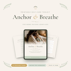 May include: A digital self-care toolkit titled "Anchor & Breathe" for moms raising ADHD kids. The image features a tablet displaying the toolkit's cover, with additional printable pages. The design includes soft colors and botanical accents.