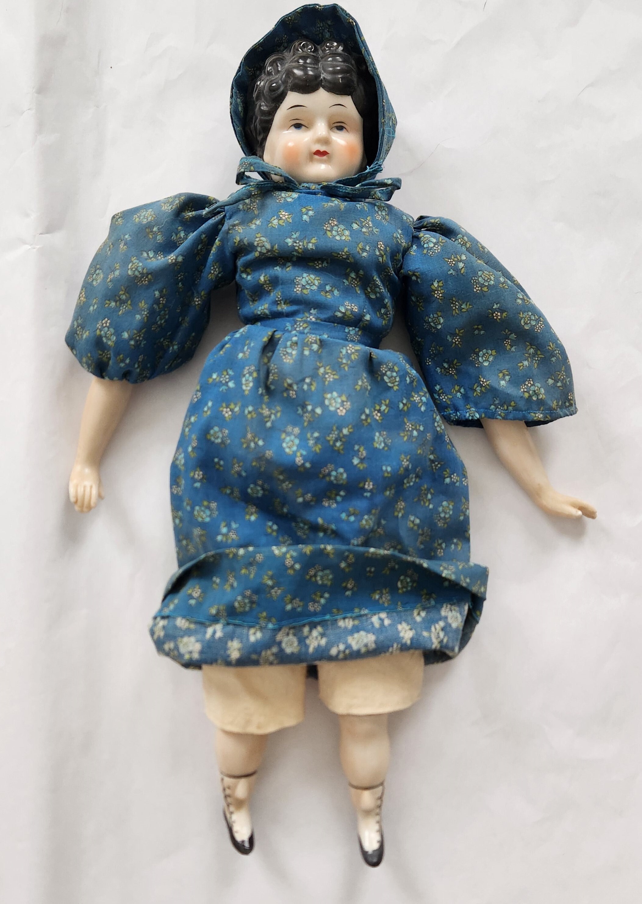 Bisque doll dressed in handmade clothes, 1890-1900