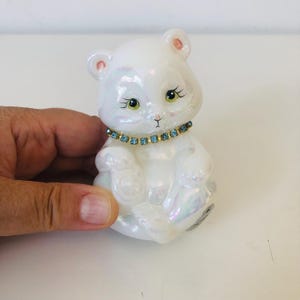 Vintage Fenton art glass bear with white iridescent finish and light blue rhinestone necklace
