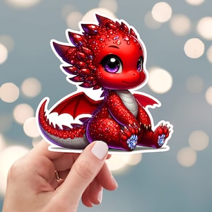 May include: A red, sparkly dragon with large eyes and a small, curled tail. The dragon is sitting on its hind legs with its wings spread out behind it.