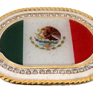 May include: Oval-shaped belt buckle with a gold-tone frame and a white background. The center features the Mexican flag with a green, white, and red design and the national coat of arms. The buckle is adorned with a row of clear rhinestones around the edge.