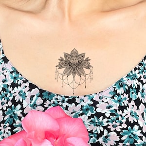 Tattoo ideas to go above the 2 flowers Sternum area  rbodymods