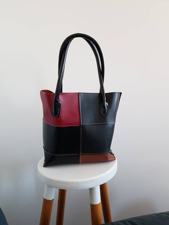 Black leather tote cheap bag with red inside