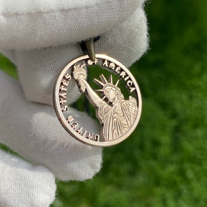 Cut Coin Pendant Backside of a Presidents Dollar Coin With the Statue of Liberty