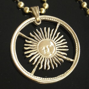 Sun, Argentinas 10 pesos cut coin pendant with necklace.