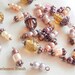 Assortment of 30 beads in shades of Brown and copper metal charms