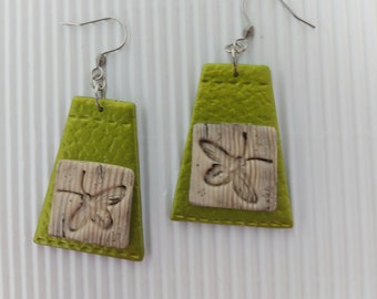 almond green trapeze-shaped earrings, leather effect, insect pattern on light old wood background, stainless steel hook, unique model