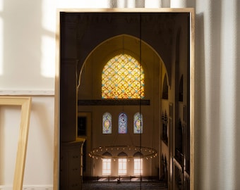May include: A framed print depicting a mosque interior. The image shows a large stained-glass window with a colourful geometric pattern. Below, three smaller stained-glass windows are visible. The interior is illuminated by natural light.