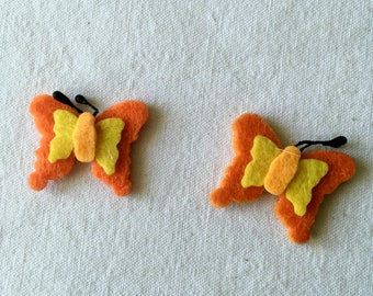 2 orange felt butterflies. Felt sticking butterfly. Beautification for decoration, scrapbooking. Textile decoration for children.