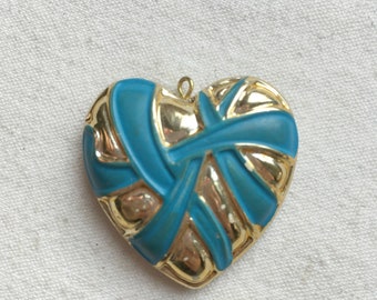 A pendant in the shape of a heart, gold and blue, vintage. Heart in gold and blue metallic resin. Golden vintage pendant for DIY jewelry.