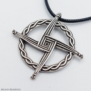 May include: A silver Celtic knot pendant necklace with a black cord. The pendant features a circular design with a cross in the center.