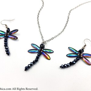 May include: A set of iridescent dragonfly earrings and a necklace. The dragonfly wings are a rainbow of colors, and the bodies are made of black beads.