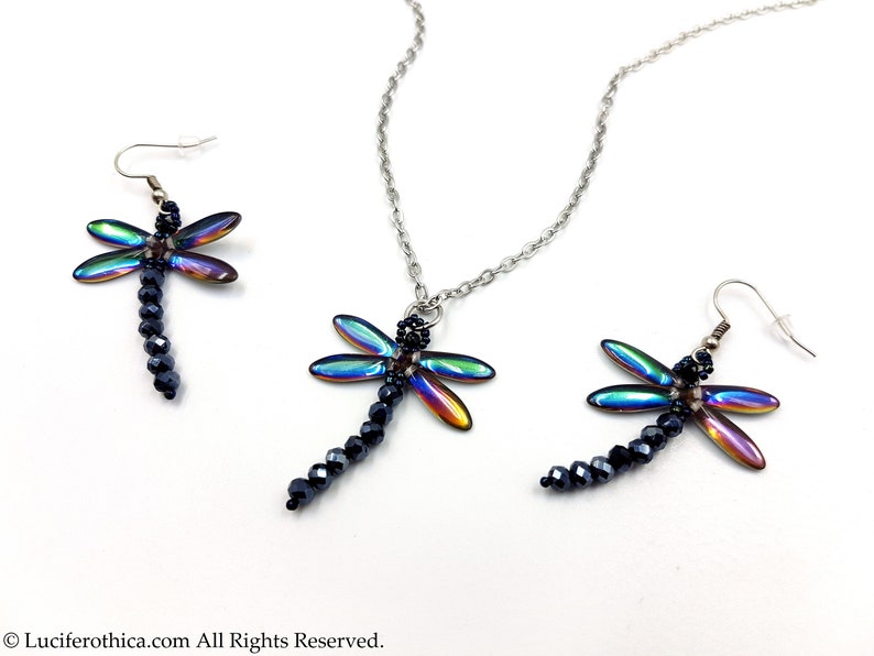 May include: A set of iridescent dragonfly earrings and a necklace. The dragonfly wings are a rainbow of colors, and the bodies are made of black beads.