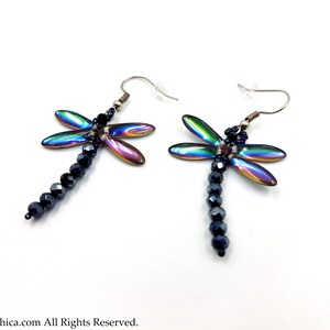 May include: A pair of iridescent dragonfly earrings with black crystal beads hanging from the dragonfly's body.