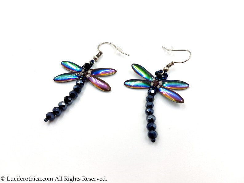 May include: A pair of iridescent dragonfly earrings with black crystal beads hanging from the dragonfly's body.