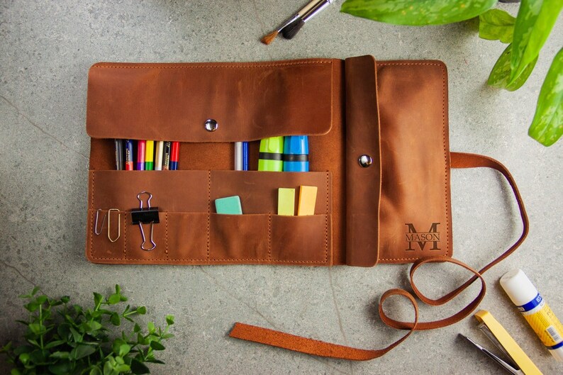 a personalized rectangular paintbrush bag holder made from solid color leather with multi-pocket, buckle, belt is the best gift for the artist