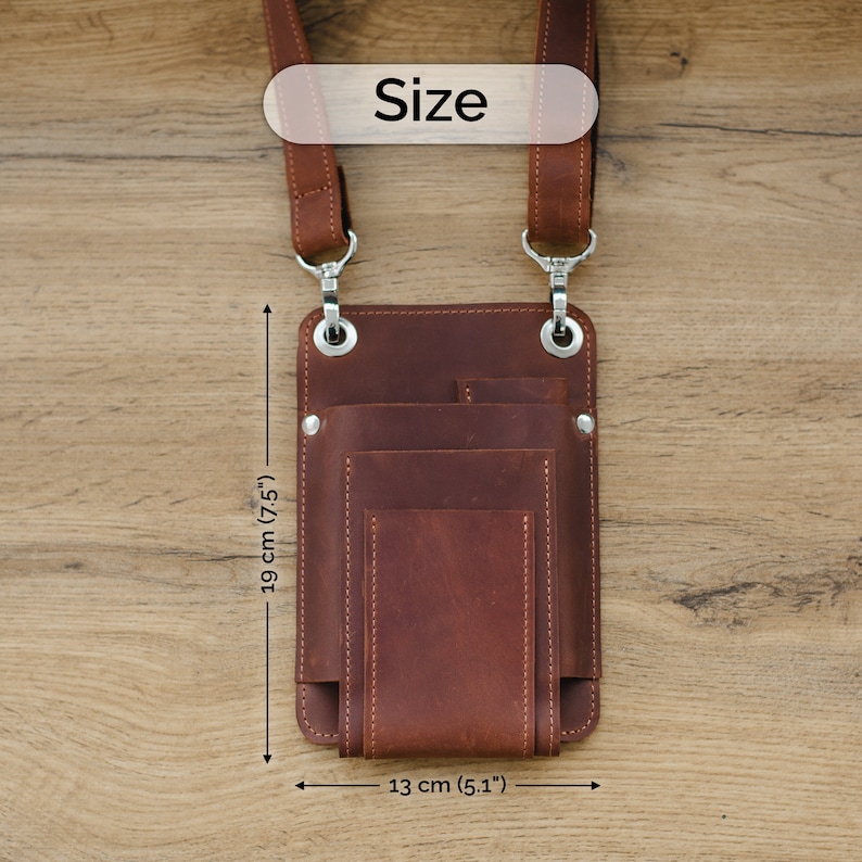 May include: Brown leather phone pouch with multiple pockets and a strap. The pouch measures 19 inches tall and 13 inches wide.