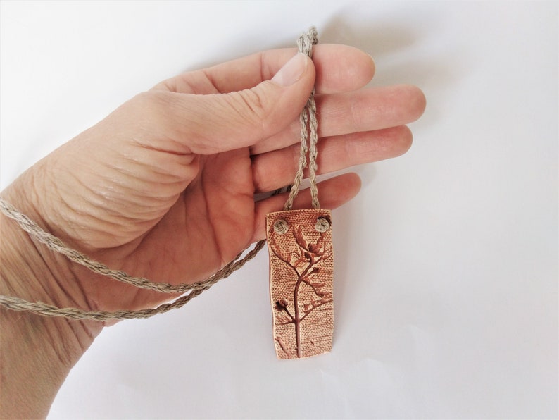 Tribulus terrestris print on ceramic pendant wild herbs of the south of Ukraine. Series Unique natural jewelry for plant lovers