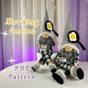 May include: Two grey gnomes wearing black and white checked pyjamas, holding coffee mugs. One gnome has a frying pan with a yellow egg on top of its hat. The other gnome has a frying pan with a yellow egg on top of its hat. The gnomes are sitting on a white surface. The text "Morning Gnome PDF Pattern" is written in yellow letters on a white background.