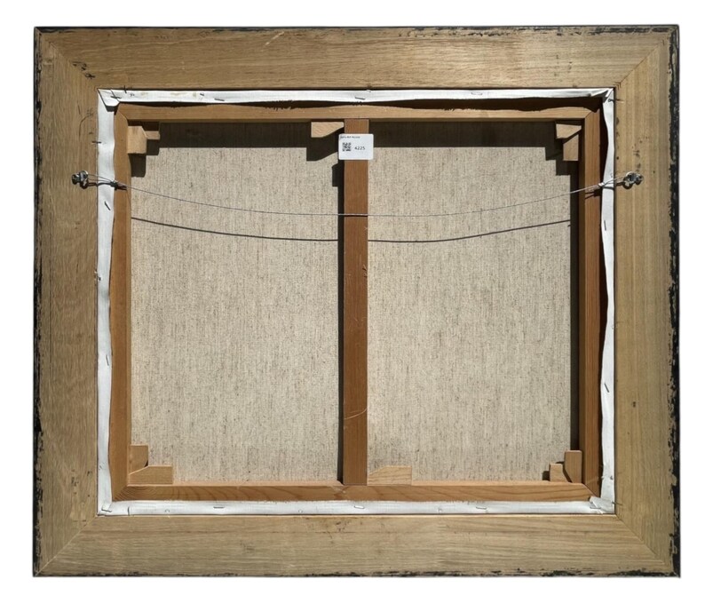 May include: The back of a framed canvas painting. The wooden frame is a light brown color with a dark brown trim. The canvas is stretched over a wooden frame with a wire for hanging.