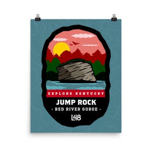 May include: A poster with a nature-themed design. The image features a rock formation over water, with a sunset and trees in the background. Text reads "EXPLORE KENTUCKY" and "JUMP ROCK - RED RIVER GORGE - L48". The poster has a blue background.