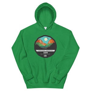 May include: Green hooded sweatshirt with a graphic of a mountain landscape and the text "Explore America Zion National Park L48".