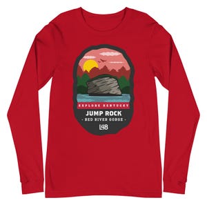 May include: A long-sleeved red shirt featuring a graphic of a rock formation with the text "JUMP ROCK - RED RIVER GORGE - L48" and "EXPLORE KENTUCKY". The graphic includes a sunset, trees, and water.