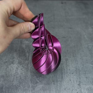 May include: A white ceramic mug with a black handle and the text "But First, Coffee" in a bold, black font. The mug is set against a blurred background, suggesting a cozy setting.