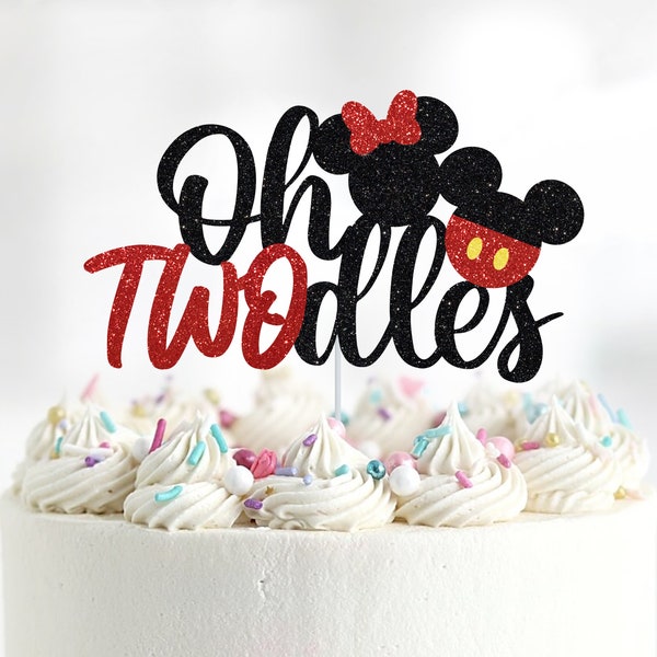 May include: A black and red cake topper with the text "Oh Twodles" and a cartoon image of Mickey and Minnie Mouse. The topper is on top of a white frosted cake with colorful sprinkles.