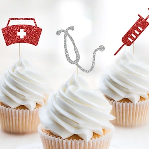 May include: Three cupcakes decorated with red and silver glitter toppers. The toppers are shaped like a nurse's hat, a stethoscope, and a syringe.
