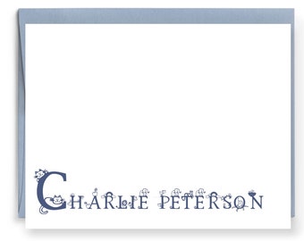 May include: A blue and white personalized stationery set with a cat design. The name "Charlie Peterson" is printed on the stationery.