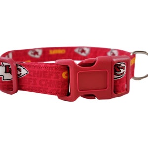 May include: Red dog collar with a Kansas City Chiefs logo pattern and a red plastic buckle.