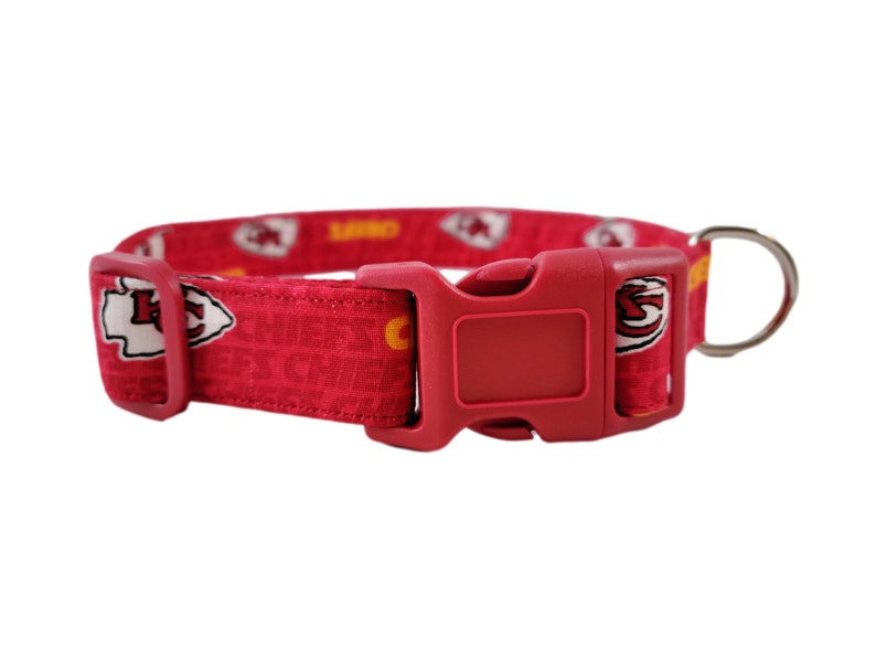 May include: Red dog collar with a Kansas City Chiefs logo pattern and a red plastic buckle.