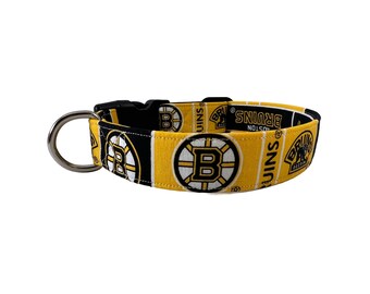 May include: A yellow and black dog collar with the Boston Bruins logo and "BRUINS BOSTON" text.