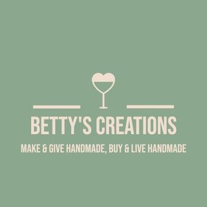 May include: Logo for Betty's Creations, featuring a wine glass with a heart-shaped top. The text reads "Betty's Creations" above the tagline "Make & Give Handmade, Buy & Live Handmade" on a muted green background.