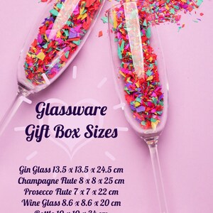 May include: Two champagne flutes filled with colorful confetti on a pink background. Text reads "Glassware Gift Box Sizes" with dimensions for gin, champagne, prosecco, wine glasses, and bottles. All sizes are approximate.