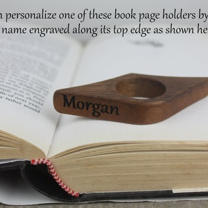 May include: A wooden book page holder with a diamond shape and a ring for holding the page. The holder is engraved with the name "Morgan".