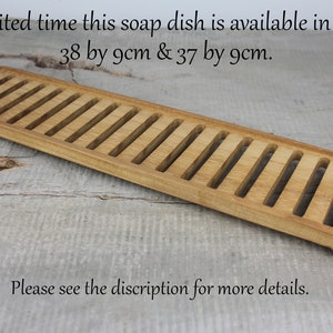 May include: A wooden soap dish with a slatted design. The dish is available in two sizes: 38 by 9 cm and 37 by 9 cm.