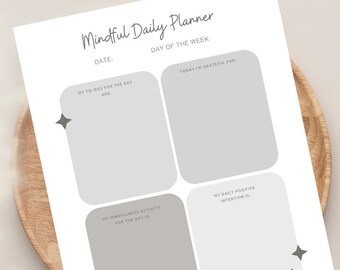 May include: A white "Mindful Daily Planner" sheet with grey text and four grey boxes for daily planning. The text includes "Date", "Day of the Week", "My To-Dos", "Today I'm Grateful For", "My Mindfulness Activity", and "My Daily Positive Intention".