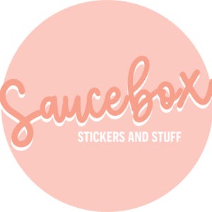 May include: A pink circle with the text "Saucebox" in white outlined pink lettering. Below the text is the phrase "Stickers and Stuff" in white text.