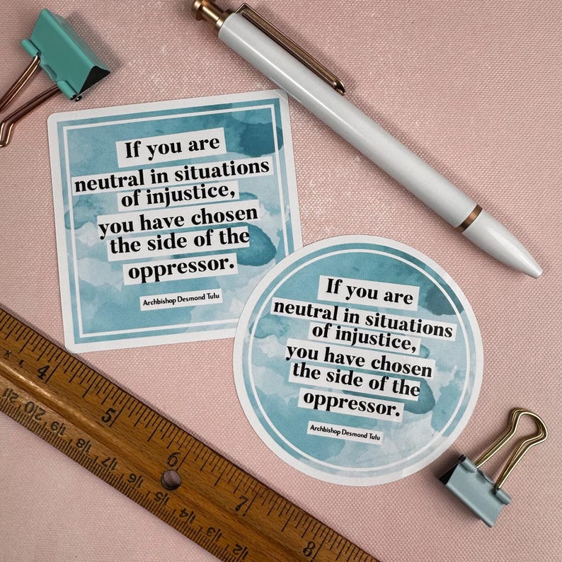 May include: Two blue watercolor stickers with a quote by Archbishop Desmond Tutu: "If you are neutral in situations of injustice, you have chosen the side of the oppressor."