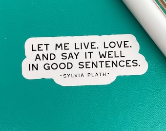 Può includere: Etichetta bianca con testo nero che recita "Lasciami vivere, amare e dirlo bene in buone frasi." Il testo è attribuito a Sylvia Plath.