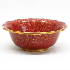 May include: A red bowl with a gold and turquoise rim and a gold floral pattern.