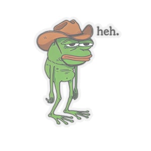 May include: A green cartoon frog wearing a brown cowboy hat with the text "heh." printed on the right side of the image.