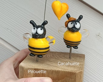 Duo bees in love on wooden block,